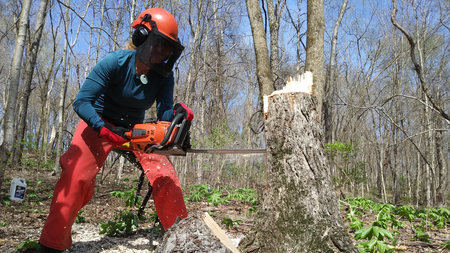 Student holding a chainsaw