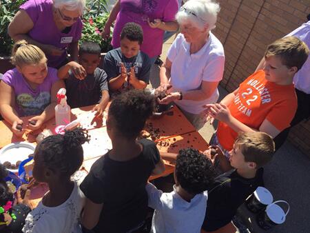 children work with Mater Gardeners on Pollinator Project