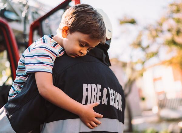fireman carrying boy 