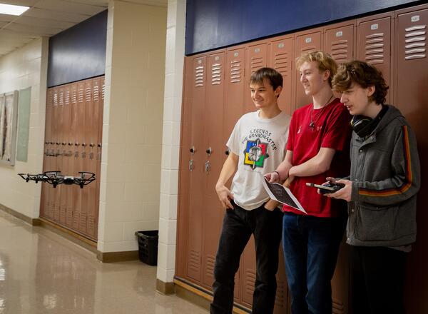 Students work together to navigate a drone.