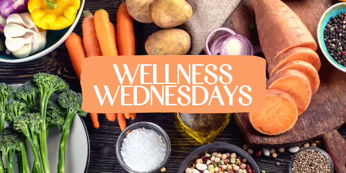 Wellness Wednesdays text centered on an orange banner over a background of fresh vegetables and healthy ingredients.