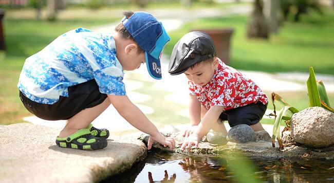 Two small children playing in water