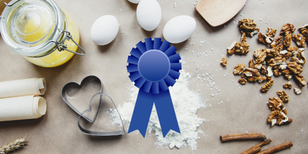 Baking supplies and ingredients with a graphic of a blue ribbon over the top of the picture. 