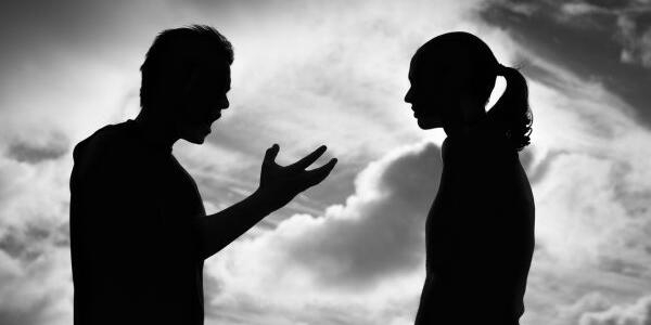 black and white photo of 2 people arguing