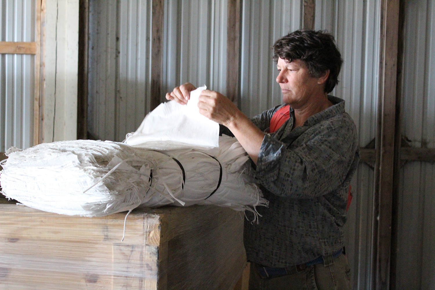 woman counting sacks for sand bags