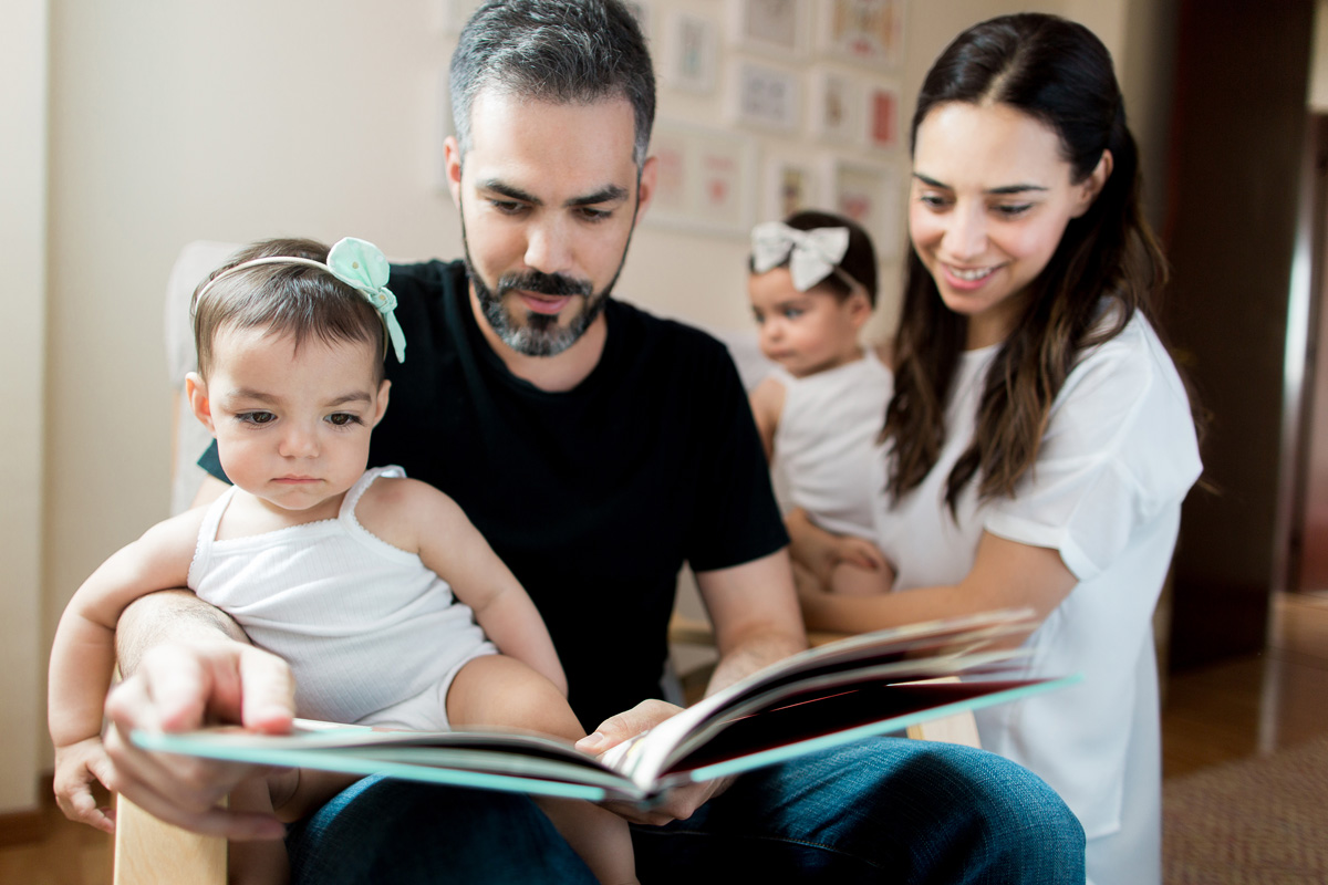 Latin family reading story together