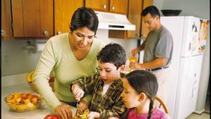 family making food together in kitchen