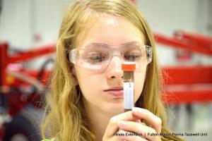 girl looking at test tube