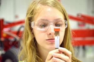 girl looking at test tube