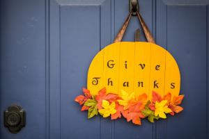 Pumpkin door decoration that says Give Thanks