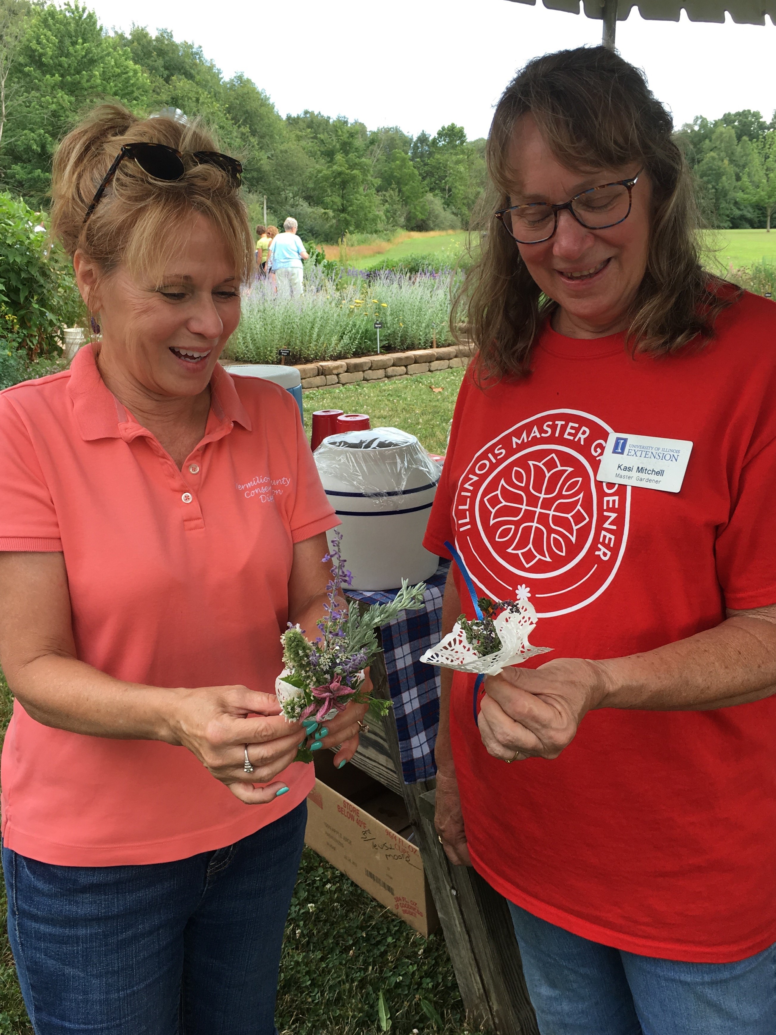 Two Master Gardeners making herb bouquets