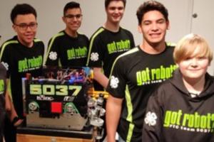 Robotics team posing with completed project
