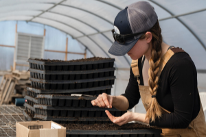 Women testing soil in a green house