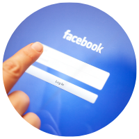 finger pointing to Facebook log in page