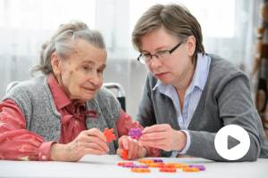 woman helping elder woman with dementia