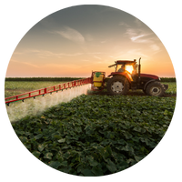 tractor spraying pesticide in field