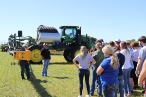 Students check out a John Deere tractor at student career day