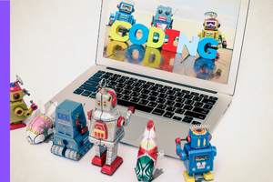 little robots around a laptop looking at screen. three robots on the screen with the word coding in front of them.
