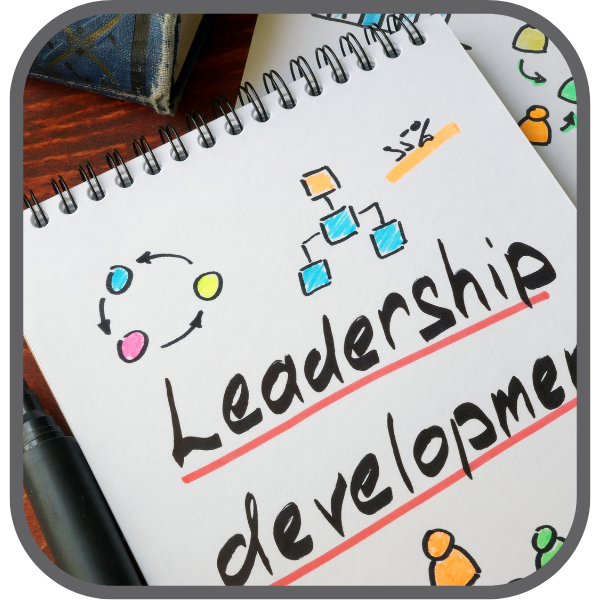 notepad with the words leadership development written on it