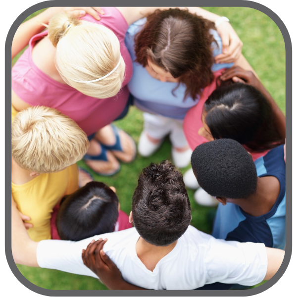 youth huddling together in a circle