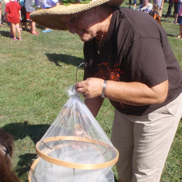 master naturalist with monarch butterflies in a net