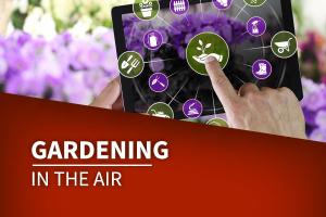 Person placing finger on IPad to select garden topic.