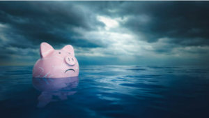 Piggy bank frowning and floating in water under cloudy dark weather