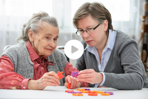 woman helping elder woman with dementia