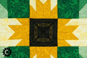 A sunflower patterned quilt with a green border.