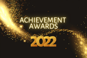 black background with gold glitter in an S curve across the middle horizontal. Text in gold says Achievement Awards 2022