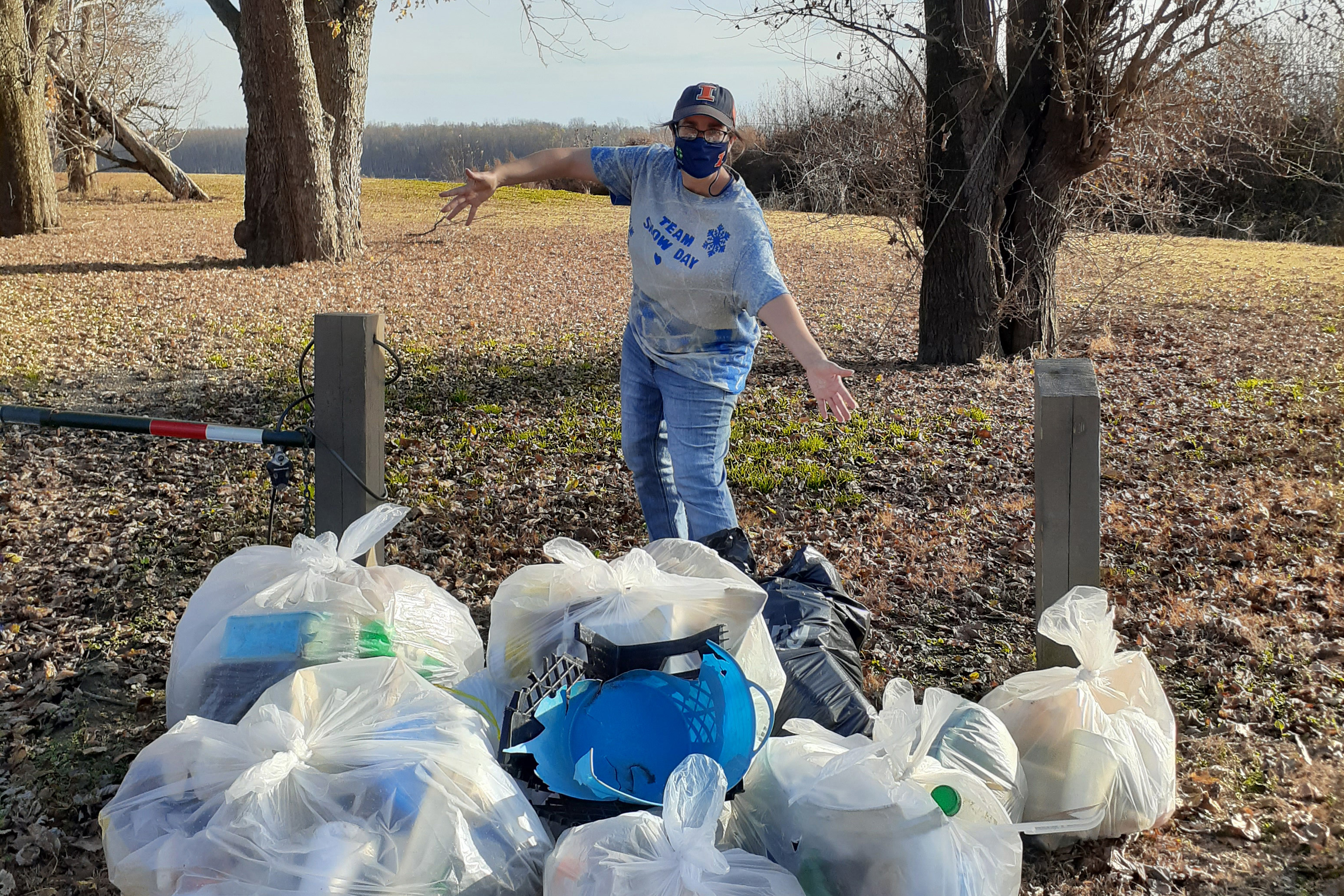 Volunteer with bags of trash collected