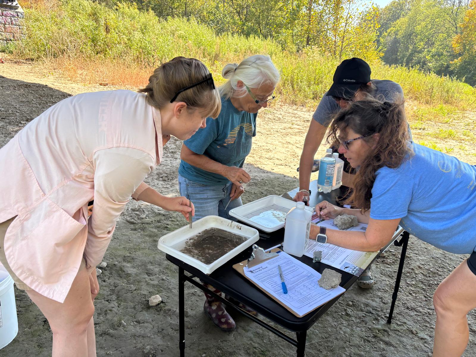 volunteers check water samples from creek