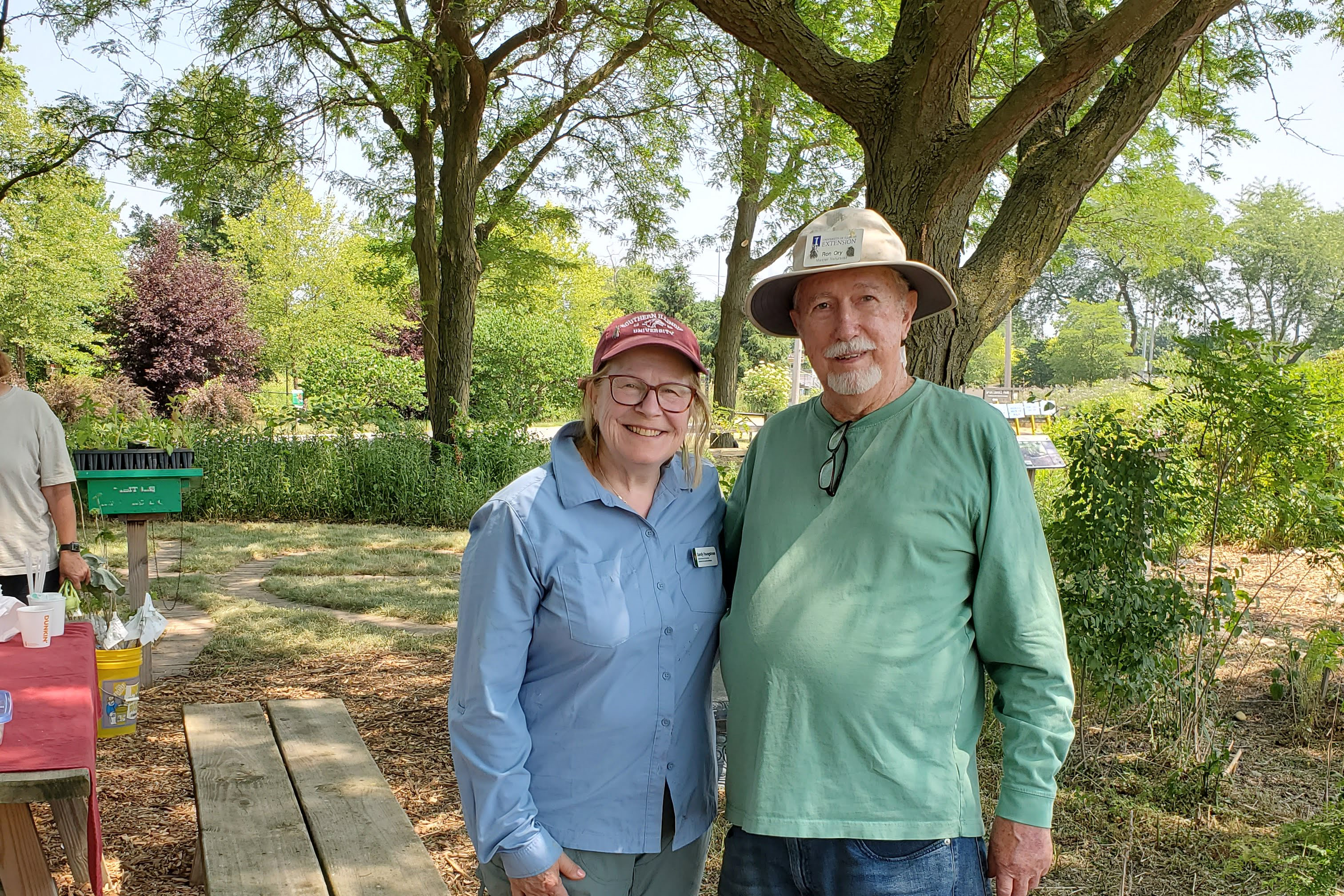 Two people smiling in a garden