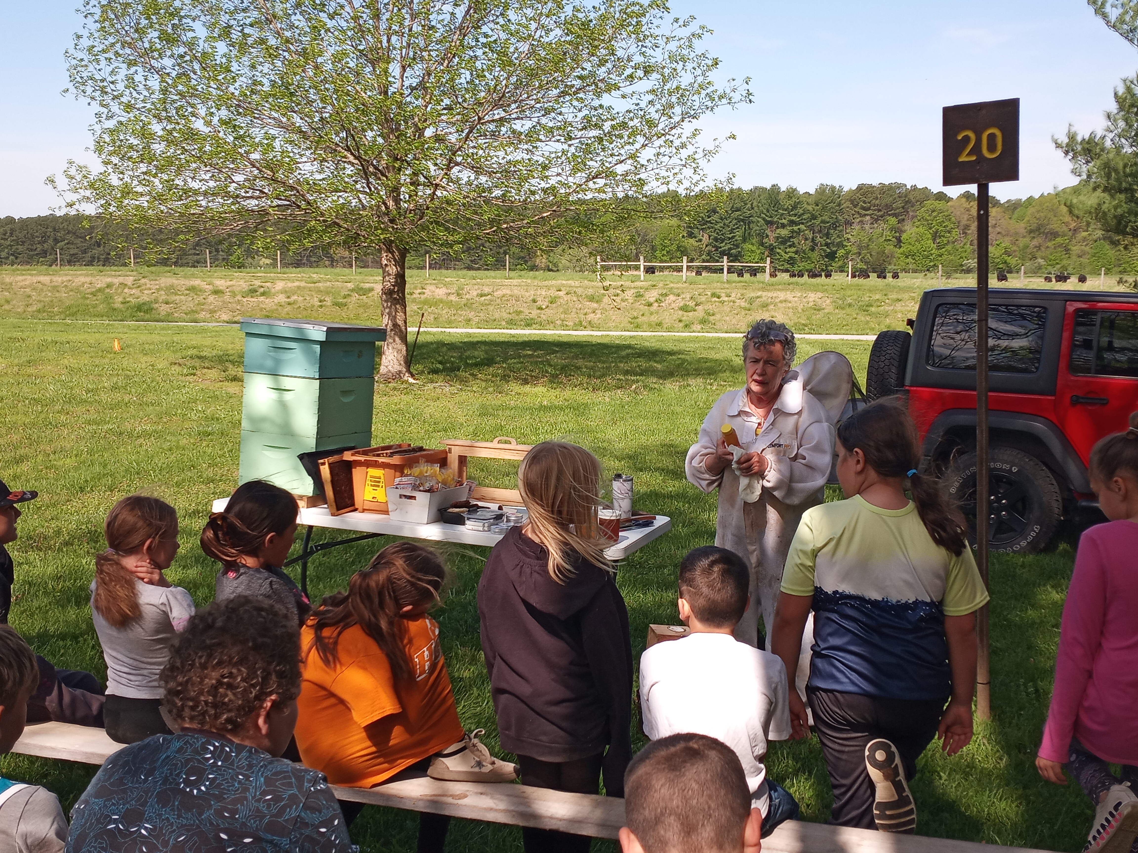 People gather outside for a bee demonstration