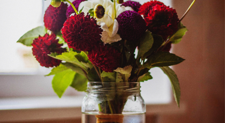 assorted cut flowers in a wide mouth jar. credit: