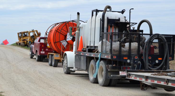 Trucks preparing to install broadband in rural setting