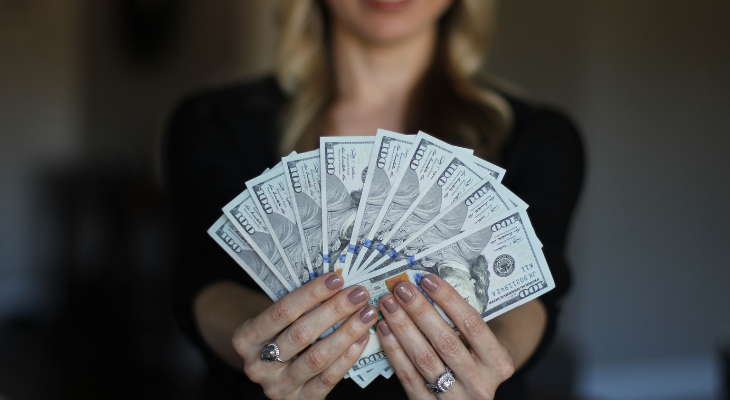 woman holding $100 bills