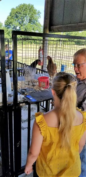 poultry exhibitor talking with the judge