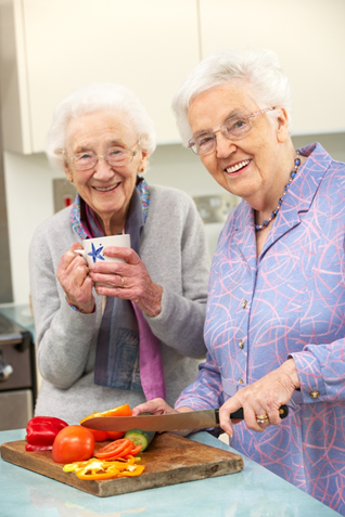 Older adults chopping veggies