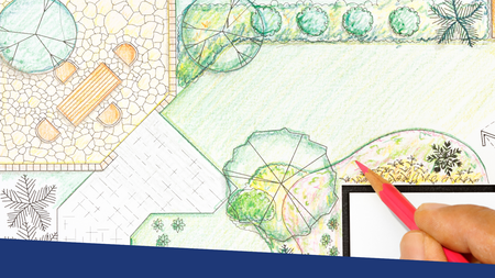 A person holding a colored pencil designing a landscape and garden.