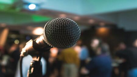 close up of a microphone with a crowd blurred in the background