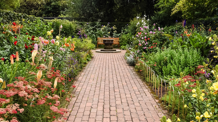 brick path between flower gardens