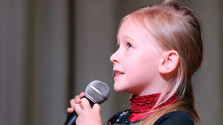 little girl holding a microphone