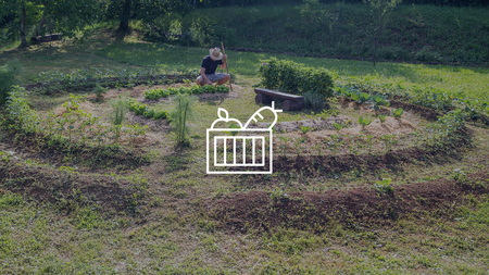 A person farming in a permaculture garden circle.