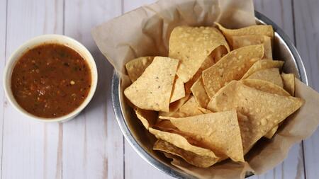 Tortilla chips and a cup of red salsa