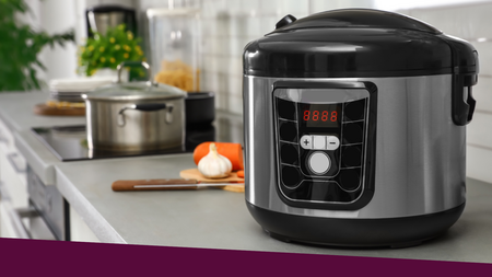 An electric pressure cooker sitting on a kitchen countertop with vegetables pots, and other items on the countertop.