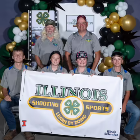 Group holding Illinois 4-H Shooting Sports banner