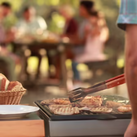 Man grilling burgers outdoors