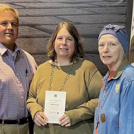 Woman receiving certificate with her guests