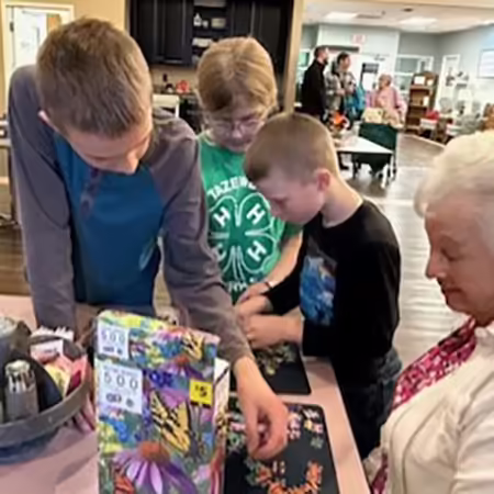 kids putting puzzle together with lady